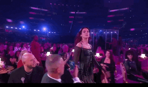 Dua Lipa walking through the crowd at the Grammys